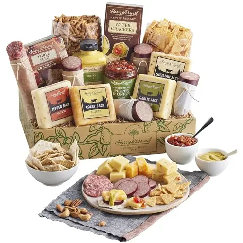 Harry & David gift box filled with sausages, blocks of cheese, crackers, sesame sticks, and sauces.