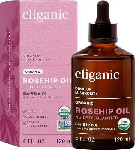 Cliganic Organic Rosehip Seed Oil bottle with dropper on wooden surface