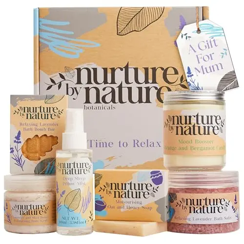 Nurture by Nature self-care gift set with a soy candle, pillow spray, bath bomb, and body scrub.