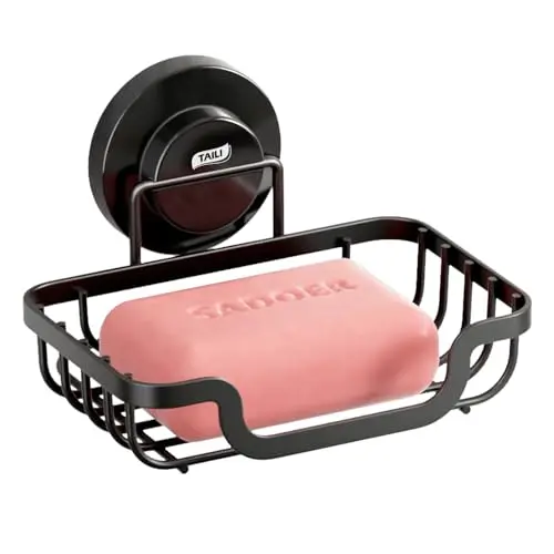 Black stainless steel soap dish with a large suction cup mount, featuring a hollowed-out drainage design.