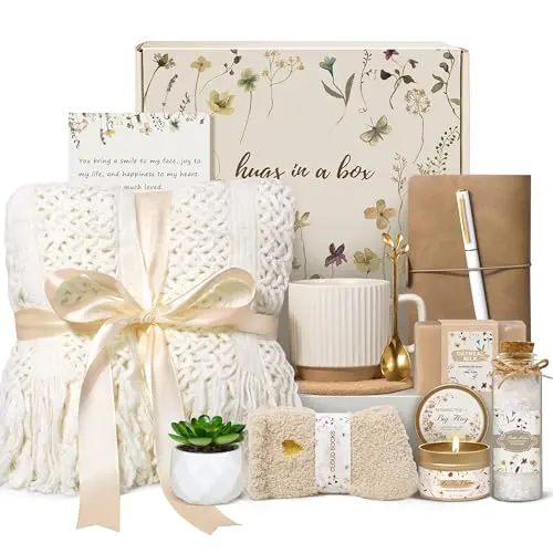 Lepiche ivory-colored gift box with a knitted tassel blanket, ceramic mug, candle, and bath salts.