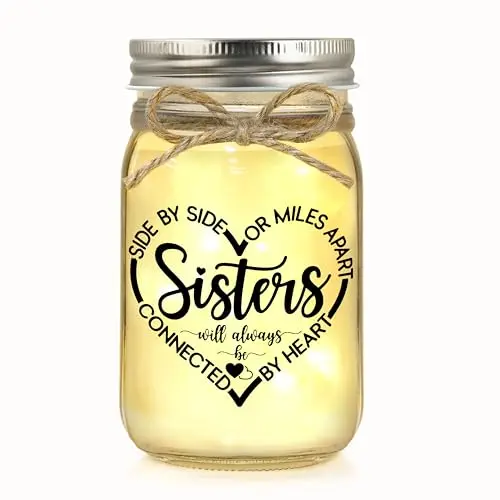 Clear glass mason jar night light with a string of warm lights and a sister quote